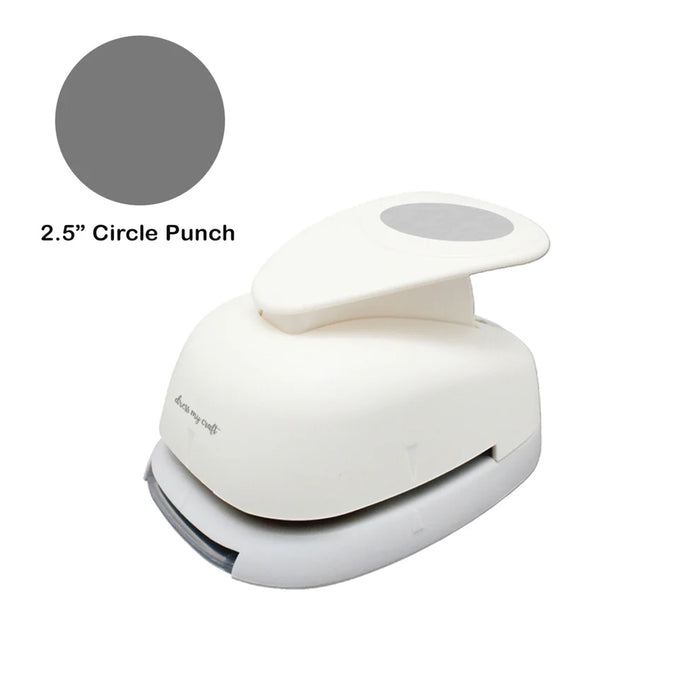 A cream-colored Dress My Craft 2.5" Circle Punch with a gray lever and a gray circle graphic indicating the punch shape and size.