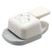 An isometric view of the cream and gray Dress My Craft 3-in-1 Rounded Tag Punch, showing the tag-size alignment guides on the base and the ergonomic press lever.