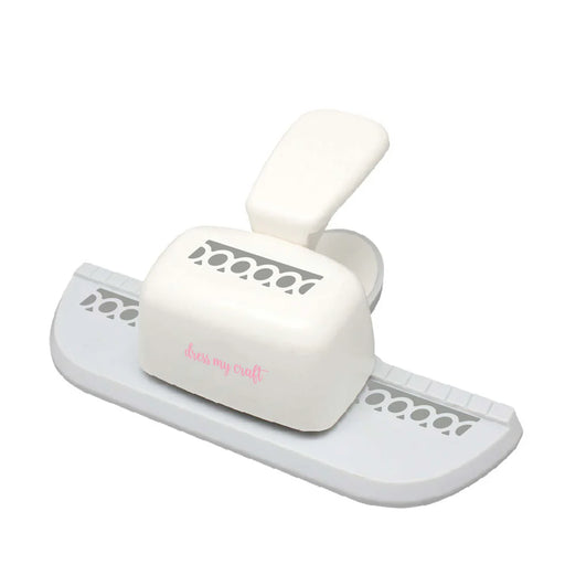 An isometric view of the cream and gray Dress My Craft Circle Chain Border Punch, showing the decorative cutting guides on the base and the ergonomic press lever.